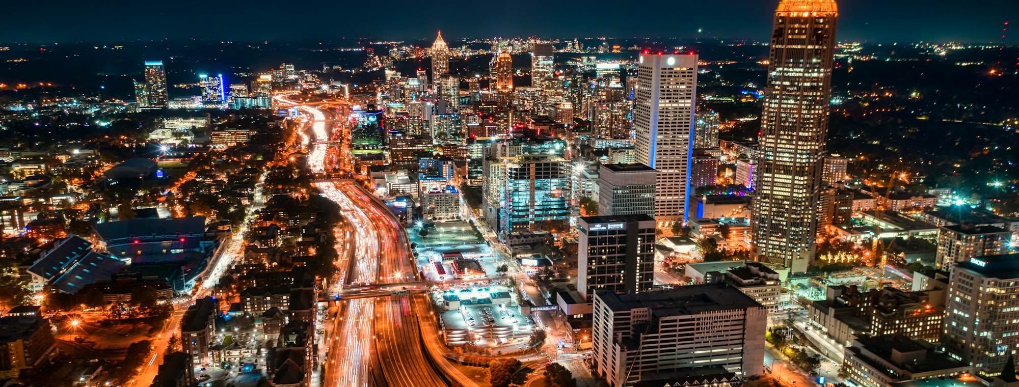 Downtown Atlanta skyline and highway light trails at night