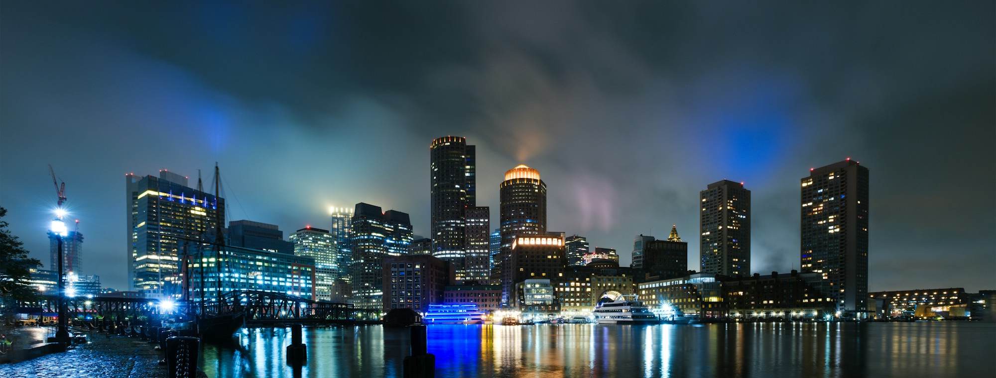 Boston skyline at night reflected in the harbor