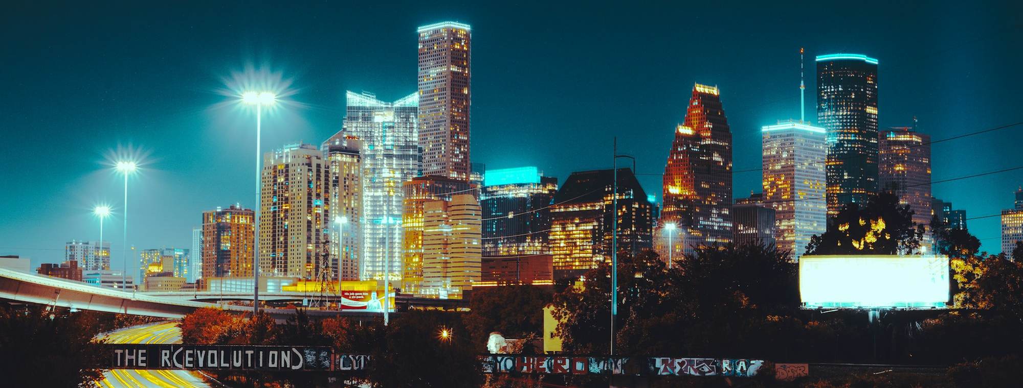 Downtown Houston skyline at night with highway light trails