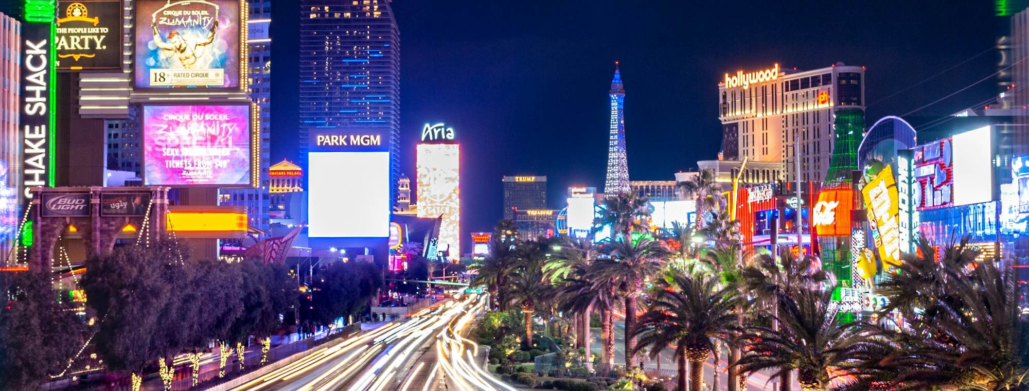 The Las Vegas Strip at night with neon signs and traffic light trails