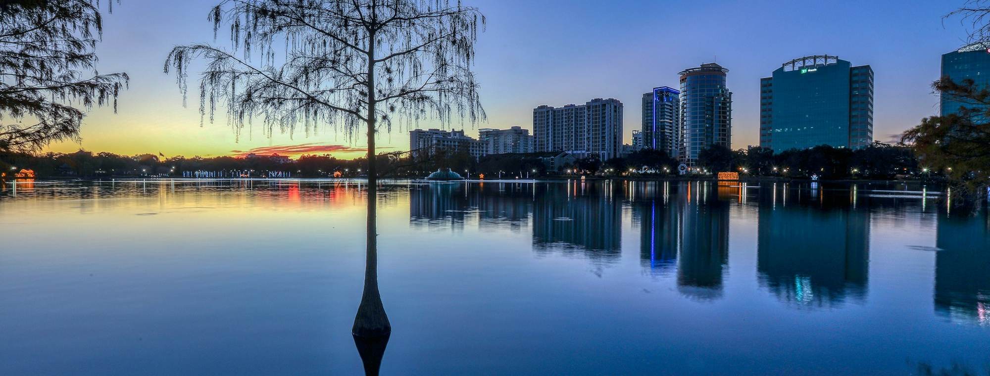 Downtown Orlando skyline reflected in Lake Eola at dusk